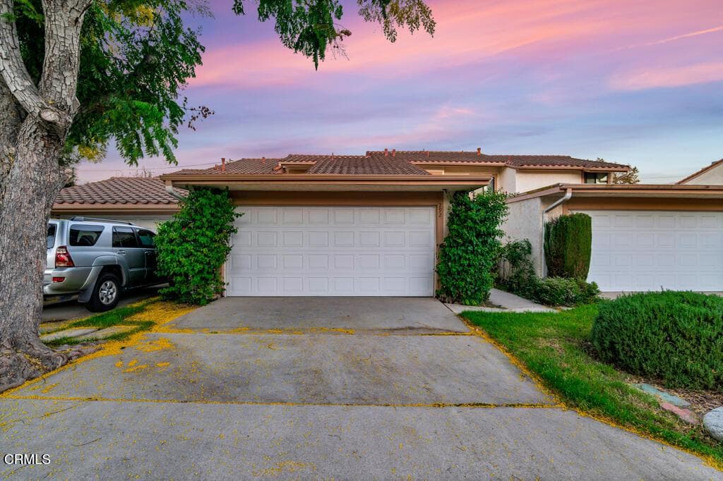 Twilight view of the front of the home and attached garage.